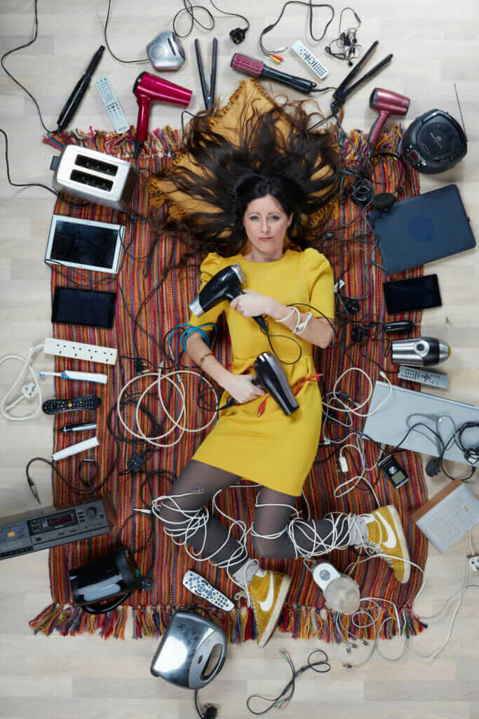 overhead shot of Natalie Fee surrounded by household electricals photo by Gregg Segal