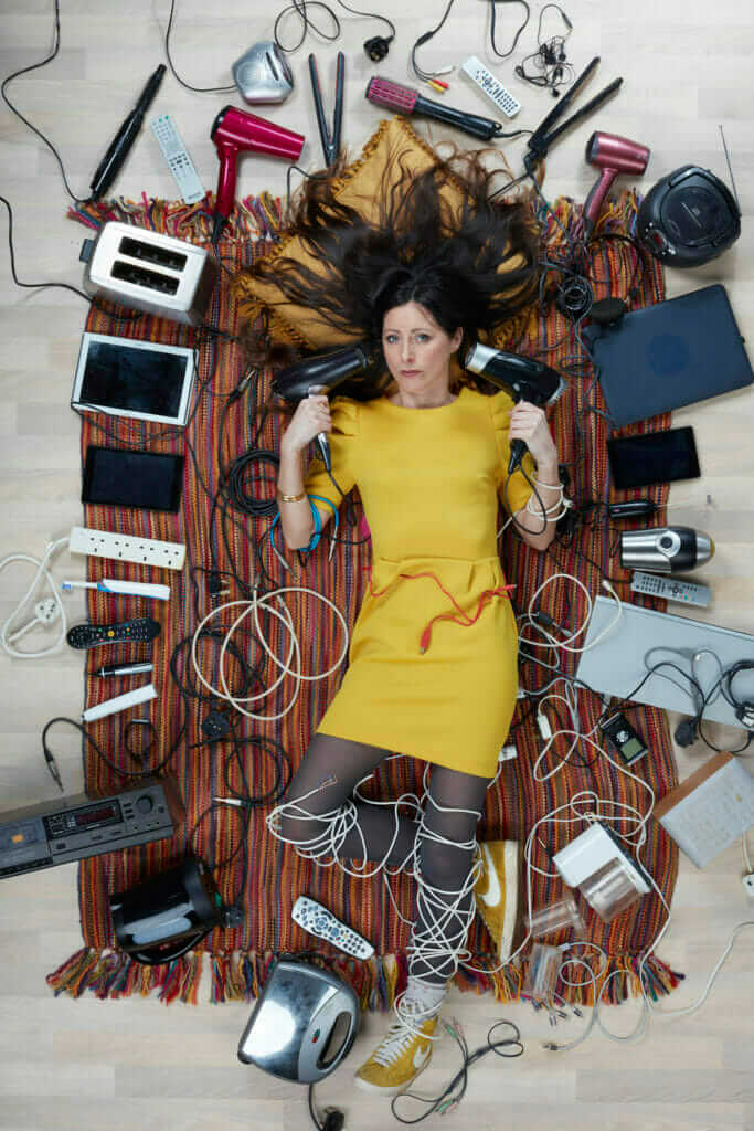 overhead shot of Natalie Fee surrounded by household electricals photo by Gregg Segal